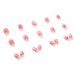 Pink gradient press-on nails with 3D camellia flowers, pearls, and crystals in ballerina shape