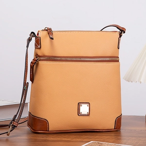 Detail of lychee pattern texture and reinforced corners on a vintage crossbody bag