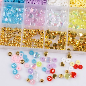Macro view of multi-color heart beads and lettered clay discs in a 24-grid jewelry DIY box