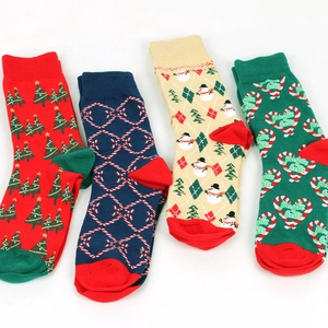 Detail of four festive Christmas crew socks featuring snowmen, candy canes, and trees