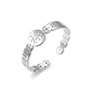 Detailed macro view of open silver ring with Good Luck Chinese characters and coin pattern