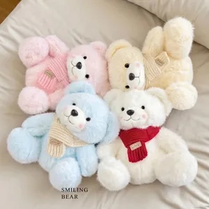 Set of four plush teddy bears in pastel colors with knit scarves on soft beige fabric