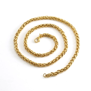Detailed close-up of a golden wheat chain necklace with a secure lobster clasp closure