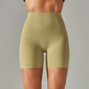Detail of high-waisted seamless yoga shorts showing olive green matte fabric texture