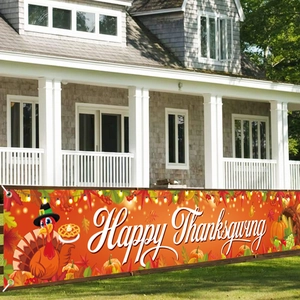 Outdoor banner with Happy Thanksgiving text, turkey and pumpkin patterns on a fence