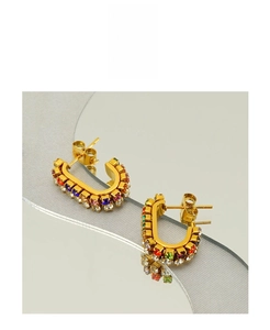 Detail of C-shaped gold-plated earrings with colorful micro-inlaid crystals and zircon stones