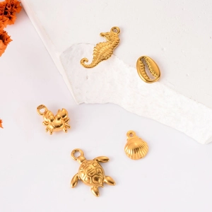 Golden stainless steel ocean pendants featuring sea horse, shell, crab and turtle shapes