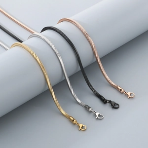 Detail of 3mm snake chains in gold, silver, black, and rose gold finishes on blue stand