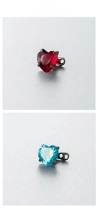 Detailed view of 6mm heart-shaped zircon piercing studs with secure four-prong setting