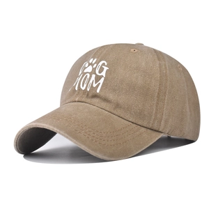Detail of Dog Mom embroidery and vintage washed texture on khaki cotton baseball cap