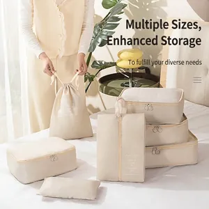 Off-white 7-piece travel organizer set with zipper bags and drawstring pouches