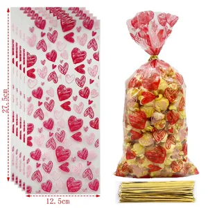 Detailed view of heart pattern candy bags with dimensions 27.5x12.5cm and gold ties