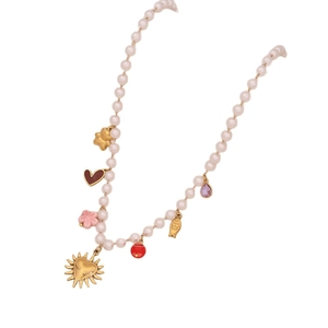 Faux pearl beaded necklace with gold heart bear flower and fish charms on white background