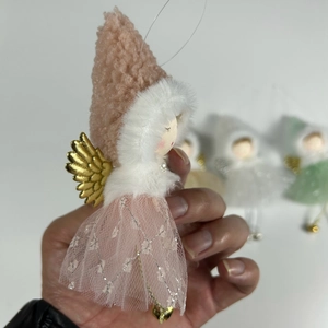 Close-up of pink angel doll ornament with mesh skirt, gold wings, and heart pendant