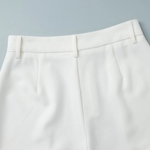 Close-up of white suit shorts waistline showing belt loops and twill fabric texture