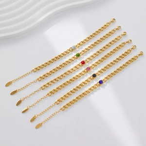 Detail of six gold Cuban link bracelets featuring colorful round zircon gemstones