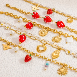 Handmade stainless steel bracelet with strawberry, pearl, and gold heart charms