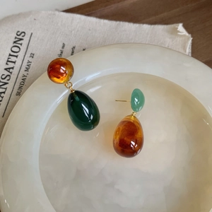 Artistic resin teardrop earrings in amber and green with gold metal accents