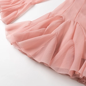 Close-up of pink chiffon fabric with layered ruffles and crinkled texture detailing