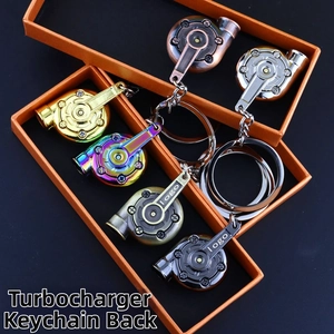 Macro detail of multicolored metal turbocharger keychains in gift boxes on blue base