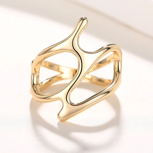 Detailed view of an avant-garde gold hollow geometric ring with irregular flowing lines