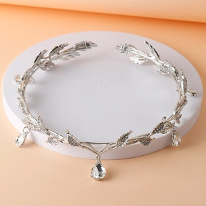 Detail of silver bridal crown featuring elegant leaf branches and waterdrop crystal pendants