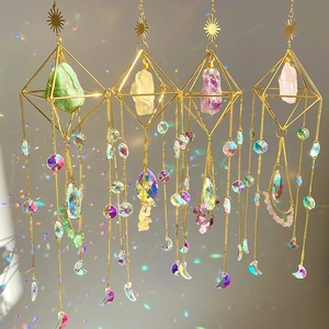 Golden sun catchers with natural raw crystals creating rainbow reflections on walls