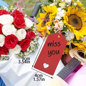 Detail of red gift tag with miss you text, heart cutout, and 9x4cm size dimensions