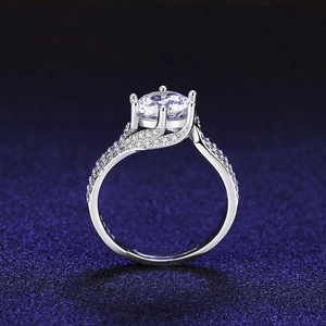 Detail of classic six-prong solitaire ring with brilliant round zircon and pavé band