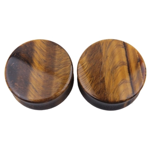 Polished natural yellow tiger eye stone ear gauges with silk luster on white background