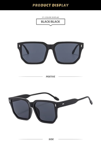 Close-up of square black frame sunglasses with dark lenses and silver metal side accents