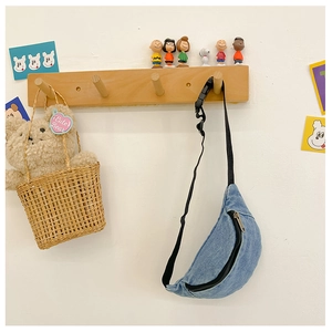 Detail of blue denim crossbody bag with adjustable strap in a cozy Zakka lifestyle setting