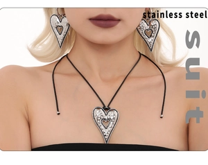Detail shot of hammered stainless steel heart pendant necklace and matching earrings set