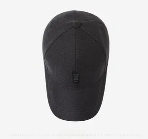 Top down detail of black baseball cap with sport tag and reinforced crown stitching