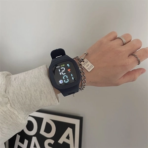 Detail view of a navy blue square LED sports watch with black silicone strap on wrist