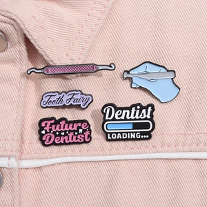 Detailed shot of cute tooth enamel pins on pink denim jacket featuring medical dental themes