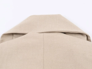 Detailed close-up of the smooth collar stitching and woven texture of the khaki blazer