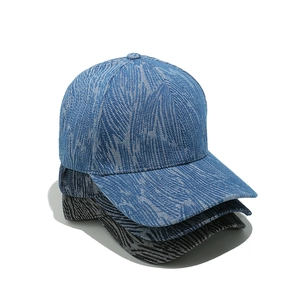 Three washed denim baseball caps in blue and black with marble texture and curved brim
