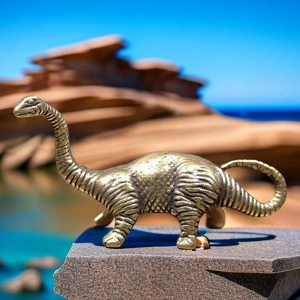 Macro detail of a vintage bronze brachiosaurus figurine showing realistic skin textures