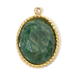 Macro detail of oval green stone pendant with golden beaded border and stainless steel frame