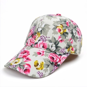 Detail view of the retro floral pattern on the canvas sun hat showing material texture