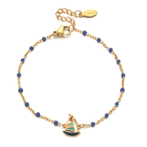 Detail of a gold stainless steel bracelet with blue beads and a colorful sailboat charm