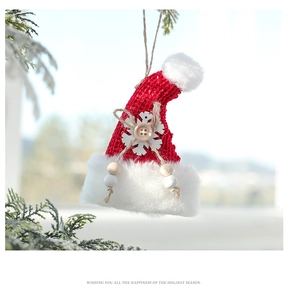 Close-up of red knitted Christmas hat ornament with plush trim and snowflake detail