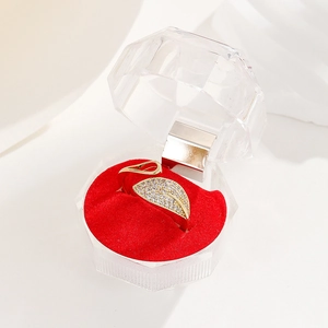 Macro view of 18K gold leaf ring with zircon diamonds and red velvet display