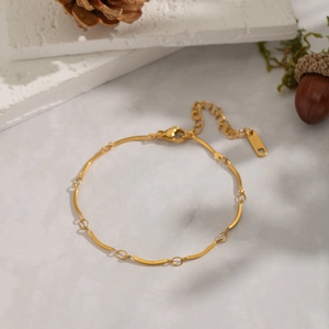 Detail of 18K gold stainless steel chain link necklace on elegant marble background