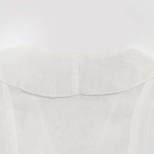 Close-up of lightweight breathable white fabric showing V-neck detail and fine texture