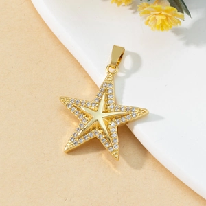Elegant gold starfish pendant with sparkling zircon stones on a soft neutral background