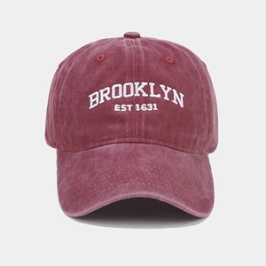 Close-up of vintage burgundy washed canvas baseball cap with white Brooklyn embroidery