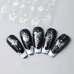 Macro view of 3D holographic silver butterfly nail art stickers on black and white nails