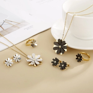 Elegant daisy jewelry set featuring necklace, earrings, and ring in gold and silver finish